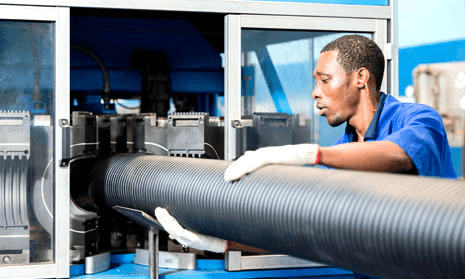 V-UK technician inspecting PVC pipe on the production line